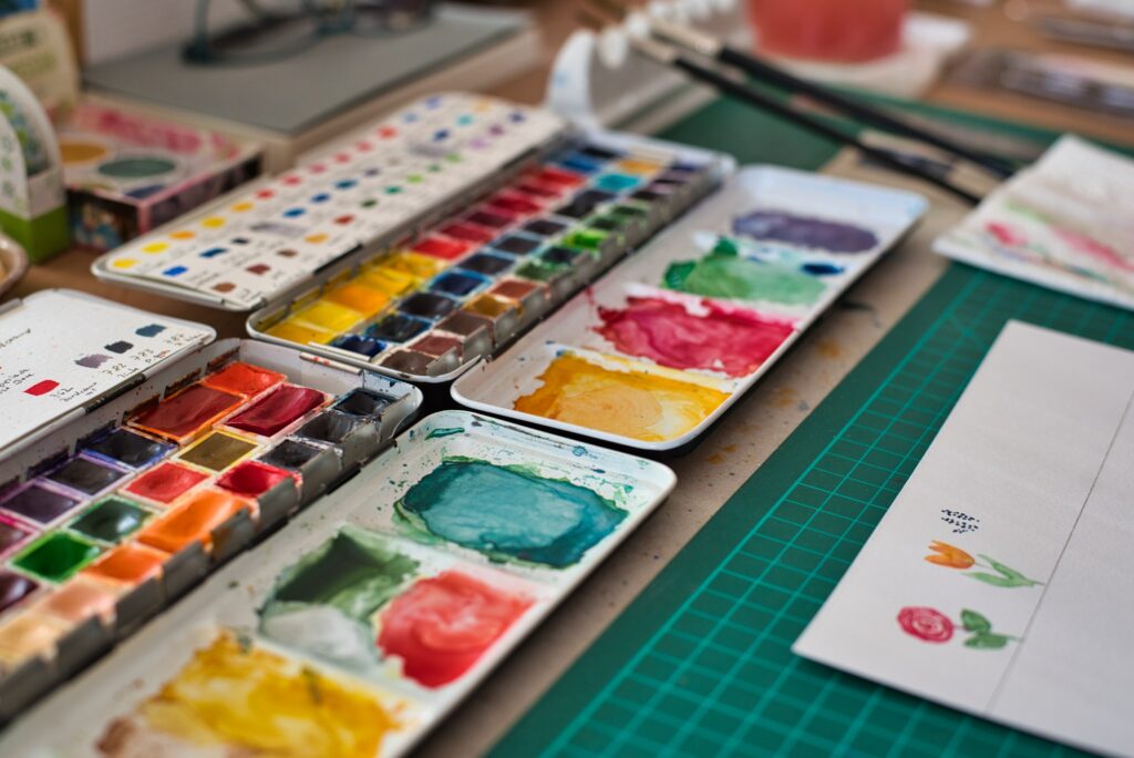 Image of a series of watercolour paint palets on an art table